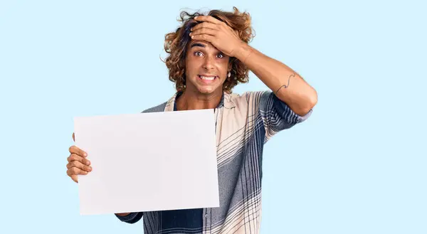 Young Hispanic Man Holding Blank Empty Banner Stressed Frustrated Hand — Stock Photo, Image