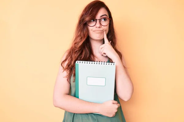 Young Beautiful Woman Wearing Glasses Holding Book Serious Face Thinking — Stock Photo, Image