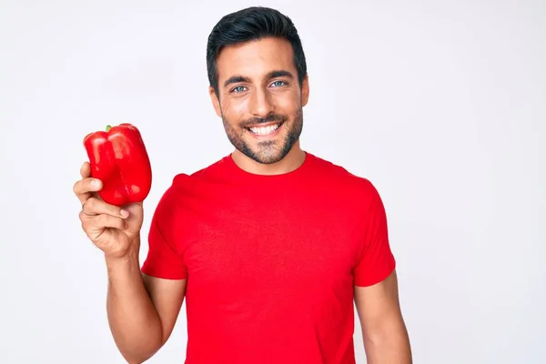 Young Hispanic Man Holding Red Pepper Looking Positive Happy Standing — Stock Photo, Image