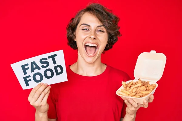 Young Hispanic Woman Holding Potato Chip Fast Food Banner Smiling — Stock Photo, Image