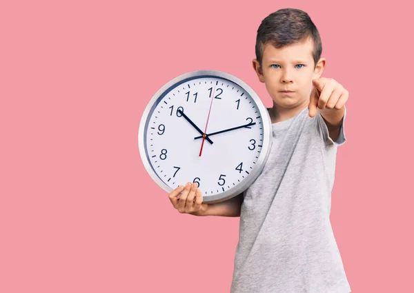 Cute Blond Kid Holding Big Clock Pointing Finger Camera You — Stock Photo, Image