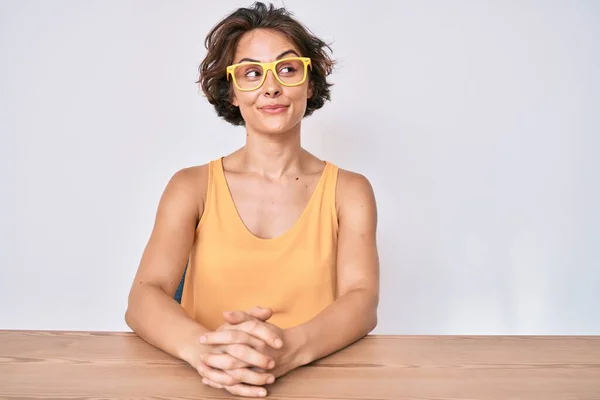 Jonge Spaanse Vrouw Casual Kleding Bril Zittend Tafel Glimlachend Naar — Stockfoto