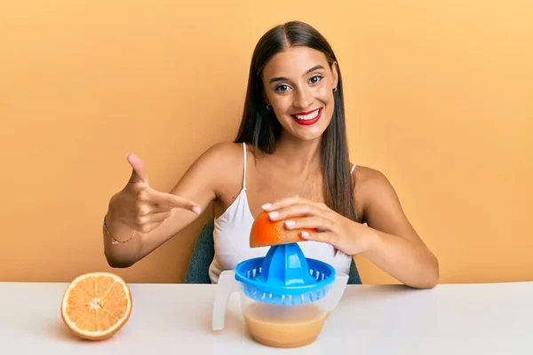 Junge Hispanische Frau Sitzt Mit Saftpresse Auf Dem Tisch Und — Stockfoto