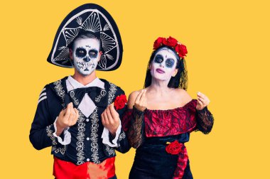 Arka planda Meksika kostümlü genç bir çift para jesti yapıyor, maaş istiyor, milyonerlik işleri yapıyor. 