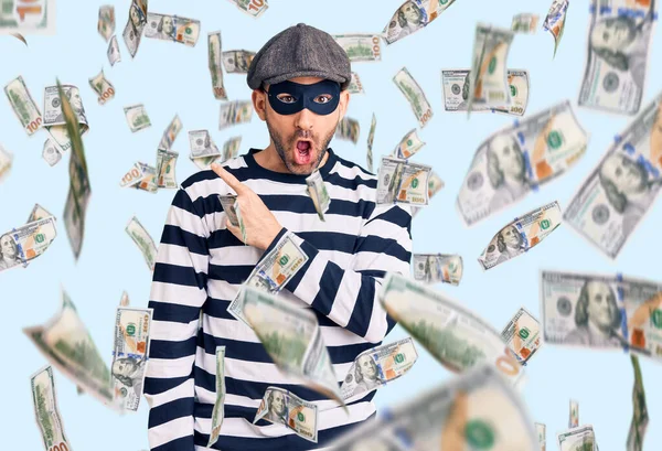 Young Handsome Man Wearing Burglar Mask Surprised Pointing Finger Side — Stock Photo, Image