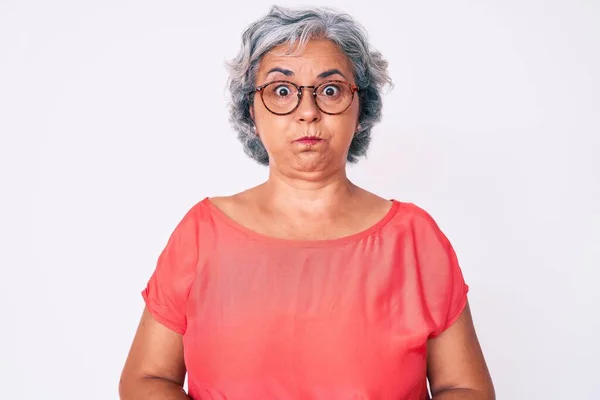 Senior Hispanic Grey Haired Woman Wearing Casual Clothes Glasses Puffing — Stock Photo, Image