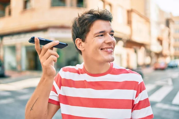 Joven Hombre Caucásico Sonriendo Feliz Escuchando Mensaje Audio Utilizando Teléfono —  Fotos de Stock