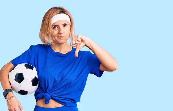 Jovem Loira Segurando Bola Futebol Com Rosto Irritado Sinal Negativo — Fotografia de Stock