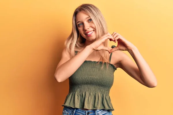 Ung Blondine Kvinde Iført Afslappet Tøj Smilende Kærlighed Gør Hjerte - Stock-foto