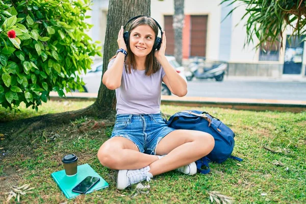 若い中東の学生の女の子笑顔幸せな使用してヘッドフォンで大学のキャンパス — ストック写真