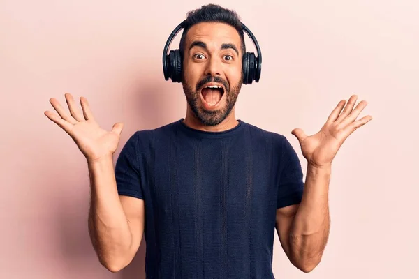 Young Hispanic Man Listening Music Using Headphones Celebrating Victory Happy — Stock Photo, Image