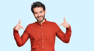 Günlük kıyafetler giyen, kendine güveni olan, kendini gururlu ve mutlu gösteren genç İspanyol bir adam.. 