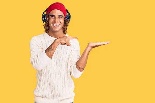 Young Hispanic Man Listening Music Using Headphones Amazed Smiling Camera — Stock Photo, Image