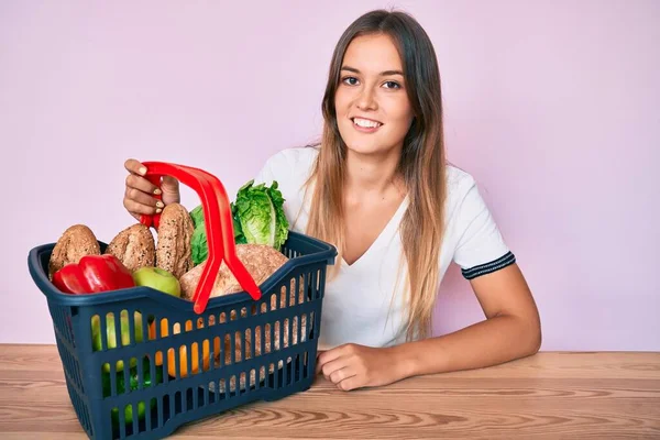 Beautiful Caucasian Woman Holding Supermarket Shopping Basket Looking Positive Happy — Stock Photo, Image