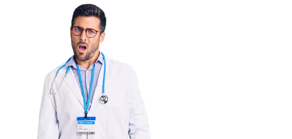 Young Hispanic Man Wearing Doctor Uniform Stethoscope Shock Face Looking — Stock Photo, Image