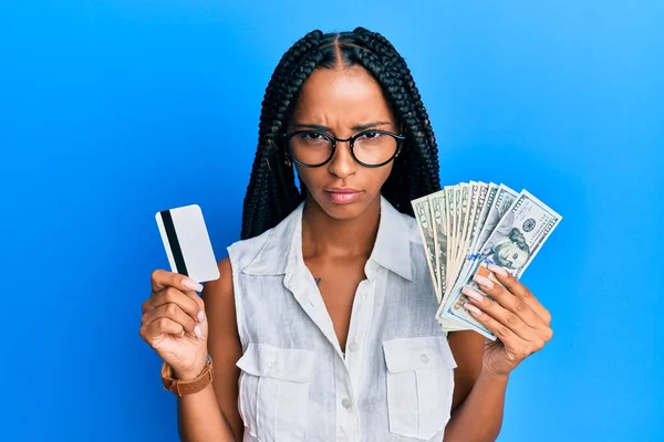 Beautiful Hispanic Woman Holding Dollars Credit Card Skeptic Nervous Frowning — Stock Photo, Image