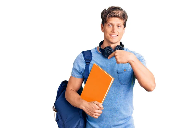 Jovem Homem Bonito Vestindo Mochila Estudantil Fones Ouvido Segurando Livro — Fotografia de Stock