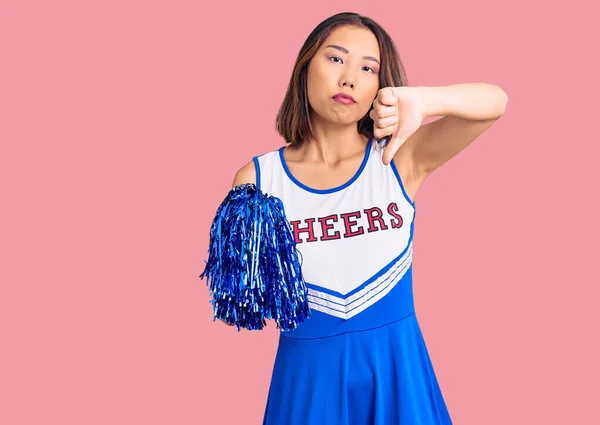 Young Beautiful Chinese Girl Wearing Cheerleader Uniform Holding Pompom Angry — Stock Photo, Image