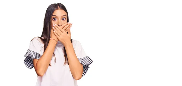 カジュアルな服を着た若いヒスパニック系の女性がミスのために手で口をカバーショックを受けた 秘密の概念 — ストック写真