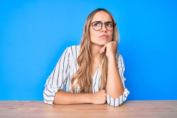 Young Beautiful Blonde Woman Wearing Glasses Sitting Table Serious Face — Stock Photo, Image