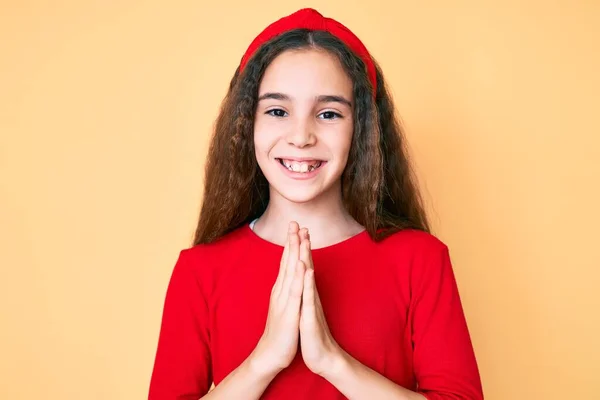 Cute Hispanic Child Girl Wearing Casual Clothes Diadem Praying Hands Stock Image