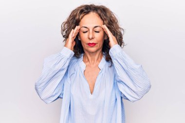 Orta yaşlı, esmer, çizgili gömlek giyen güzel bir kadın. Beyaz arka planda duruyor. Başı baş üstünde, stres yüzünden baş ağrısı çekiyor. Migren ağrısı..