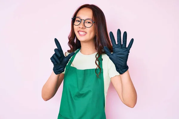 Young Beautiful Chinese Girl Wearing Cleaner Apron Showing Pointing Fingers — Stock Photo, Image