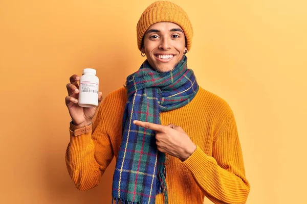 Young African Amercian Man Wearing Winter Clothes Holding Pills Smiling — Stock Photo, Image