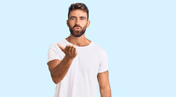 Young Hispanic Man Wearing Casual White Tshirt Looking Camera Blowing — Stock Photo, Image