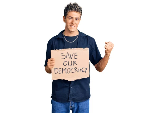 Young Handsome Man Holding Our Democracy Protest Banner Screaming Proud — Stock Photo, Image