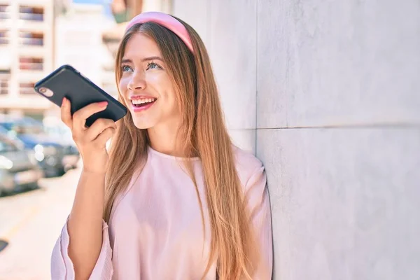 Jovem Caucasiana Sorrindo Feliz Enviando Mensagem Áudio Usando Smartphone Cidade — Fotografia de Stock