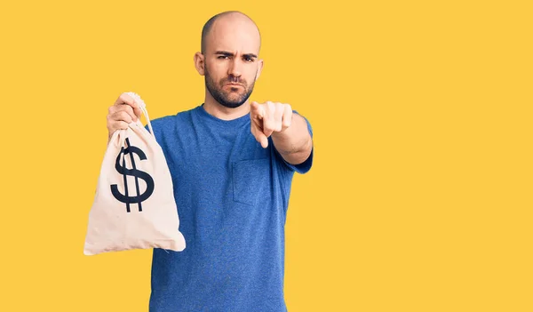 Young Handsome Man Holding Money Bag Dollar Symbol Pointing Finger — Stock Photo, Image