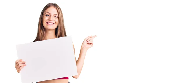 Young Beautiful Blonde Woman Holding Blank Empty Banner Smiling Happy — Stock Photo, Image