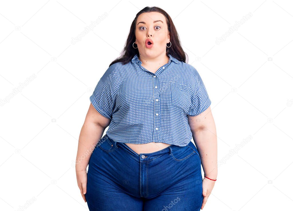 Young plus size woman wearing casual clothes scared and amazed with open mouth for surprise, disbelief face 