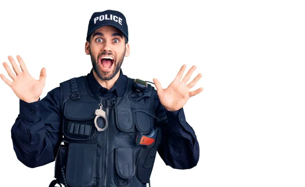 警官の制服を着た髭を生やした若いハンサムな男が狂ったことを祝い 腕を上げて興奮して叫んで目を開けて成功したことに驚きました 勝者のコンセプト — ストック写真