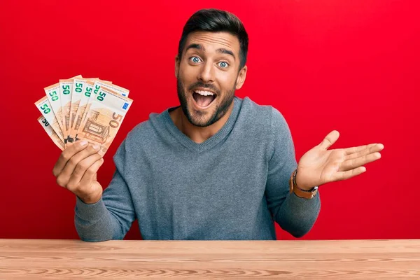 Przystojny Hiszpan Trzymający Garść Banknotów Euro Świętujących Osiągnięcie Szczęśliwym Uśmiechem — Zdjęcie stockowe