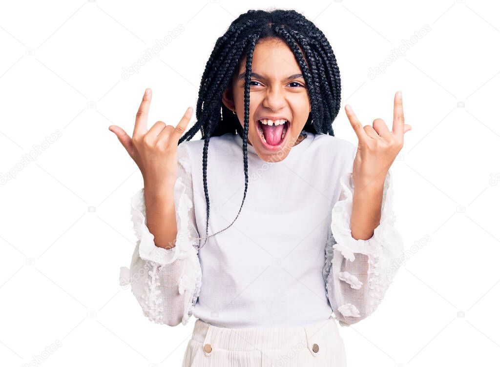 Cute african american girl wearing casual white tshirt shouting with crazy expression doing rock symbol with hands up. music star. heavy concept. 