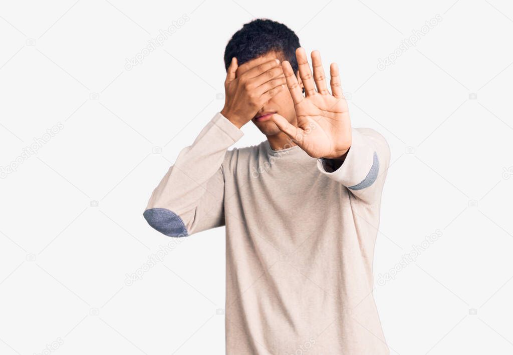 Young african amercian man wearing casual clothes covering eyes with hands and doing stop gesture with sad and fear expression. embarrassed and negative concept. 