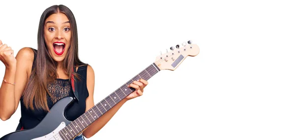 Mujer Hispana Joven Tocando Guitarra Eléctrica Gritando Orgullosa Celebrando Victoria —  Fotos de Stock