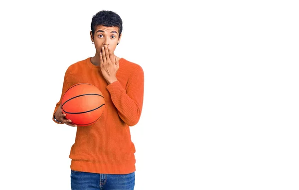 Young African Amercian Man Holding Basketball Ball Covering Mouth Hand — Stock Photo, Image