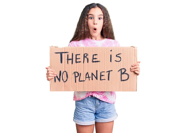 Cute Hispanic Child Girl Holding Planet Banner Scared Amazed Open — Stock Photo, Image