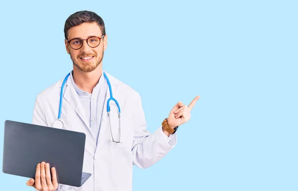 Bonito Jovem Com Urso Vestindo Uniforme Médico Trabalhando Usando Laptop — Fotografia de Stock