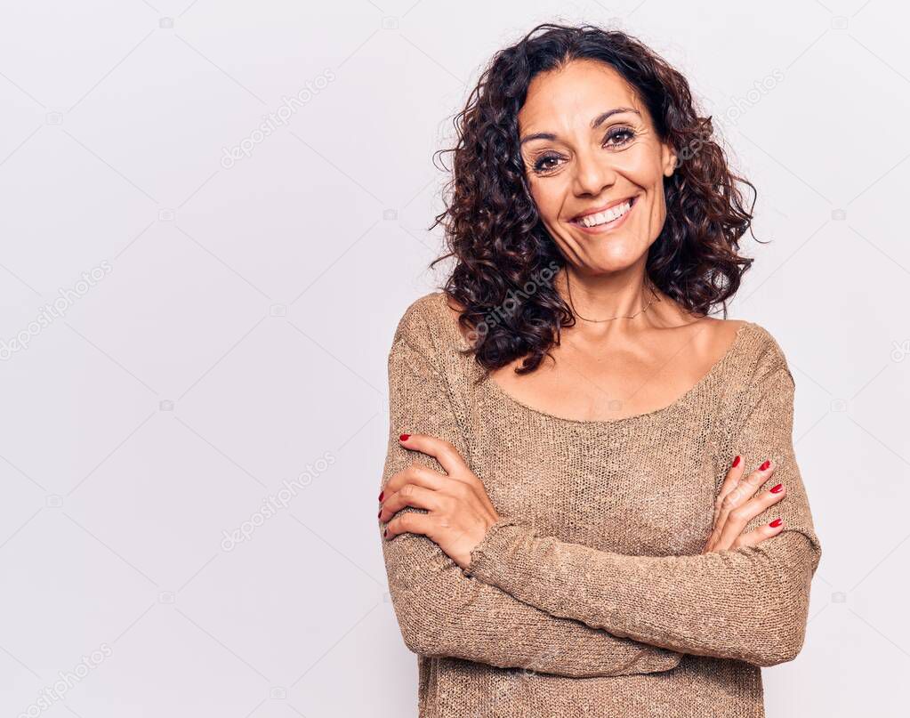 Middle age beautiful woman wearing casual sweater happy face smiling with crossed arms looking at the camera. positive person. 