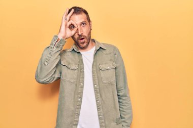 Sıradan kıyafetler giyen genç yakışıklı adam şaşırmış yüz ifadesiyle şok olmuş, parmaklarından bakan gözler. İnançsız ifade. 