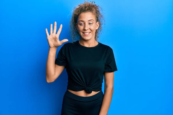 Beautiful Caucasian Teenager Girl Wearing Black Sportswear Showing Pointing Fingers — Stock Photo, Image