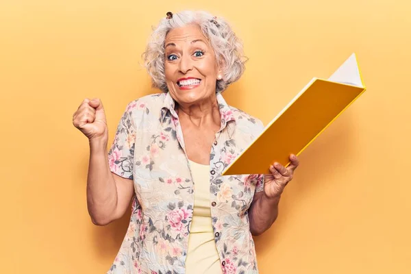 Senior Mujer Pelo Gris Sosteniendo Libro Gritando Orgulloso Celebrando Victoria —  Fotos de Stock