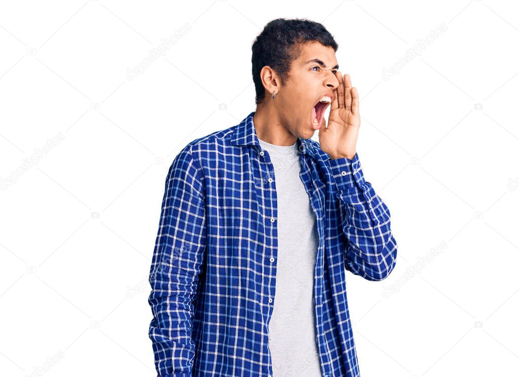Young african amercian man wearing casual clothes shouting and screaming loud to side with hand on mouth. communication concept. 