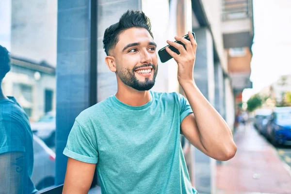 Young Arab Man Smiling Happy Listening Audio Message Using Smartphone — Stock Photo, Image