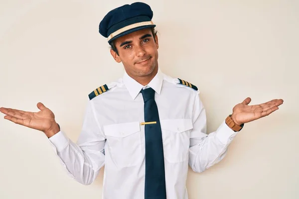 Young Hispanic Man Wearing Airplane Pilot Uniform Clueless Confused Expression — Stock Photo, Image