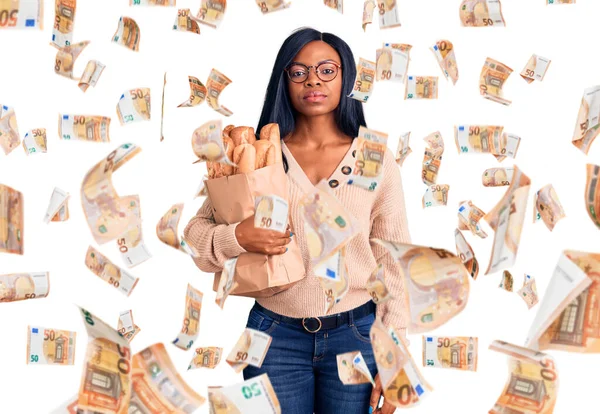 Young African American Woman Holding Paper Bag Bread Thinking Attitude — Stock Photo, Image